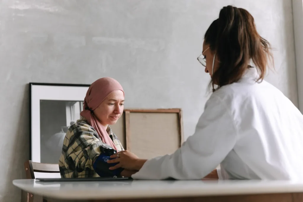 A clinician checking a patient's blood pressure